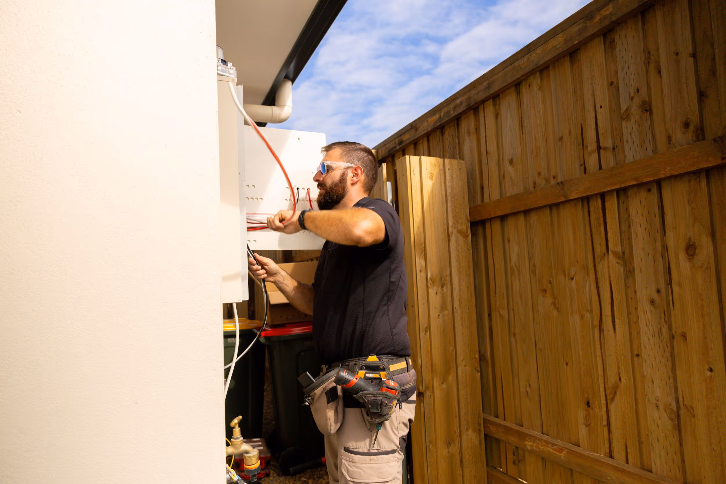 LMS Electrical in-house electrician installing a hybrid solar inverter and battery system for a residential home in South East Queensland.