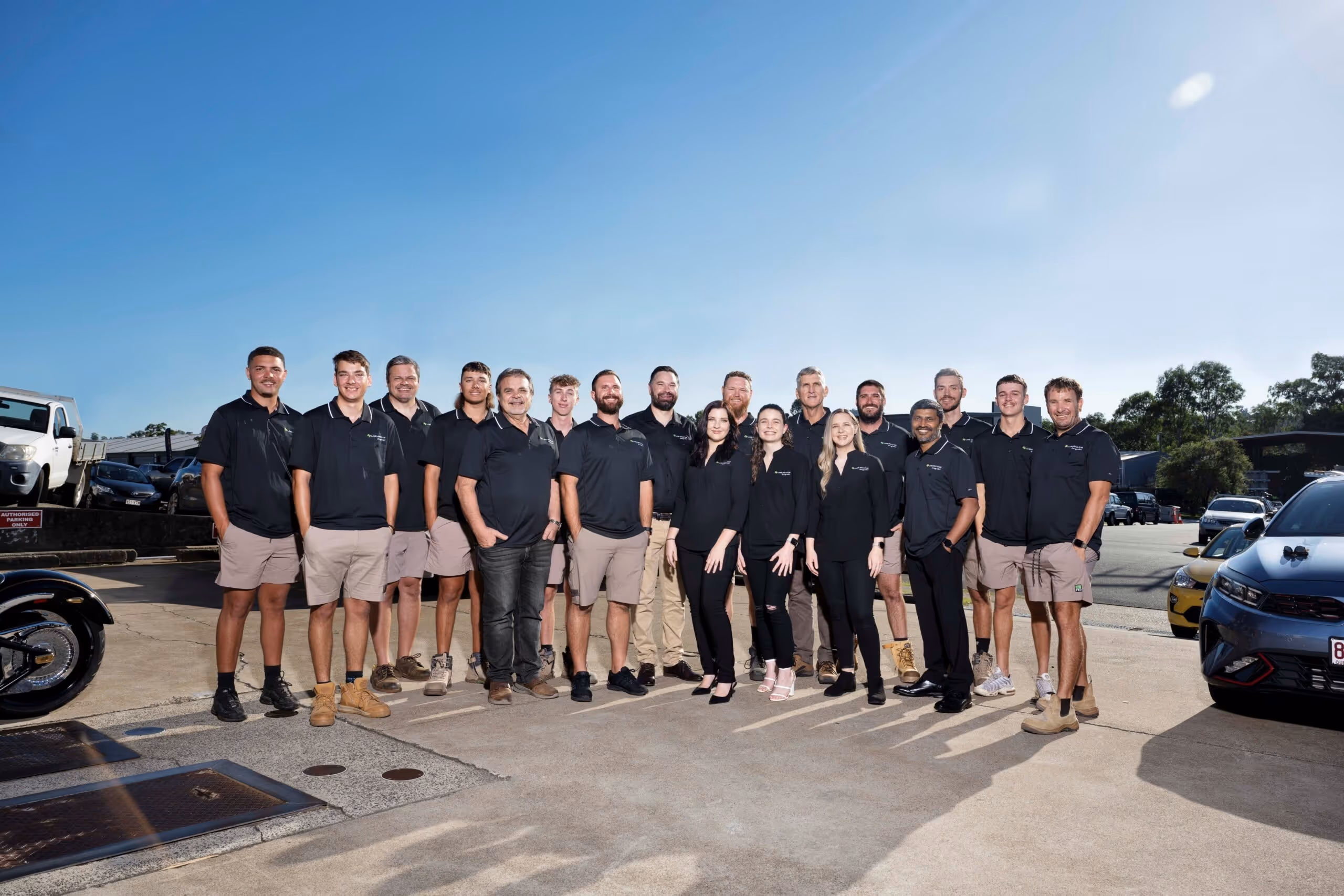 The full team of qualified in-house electricians and support staff at LMS Electrical, standing together outside their South East Queensland headquarters.