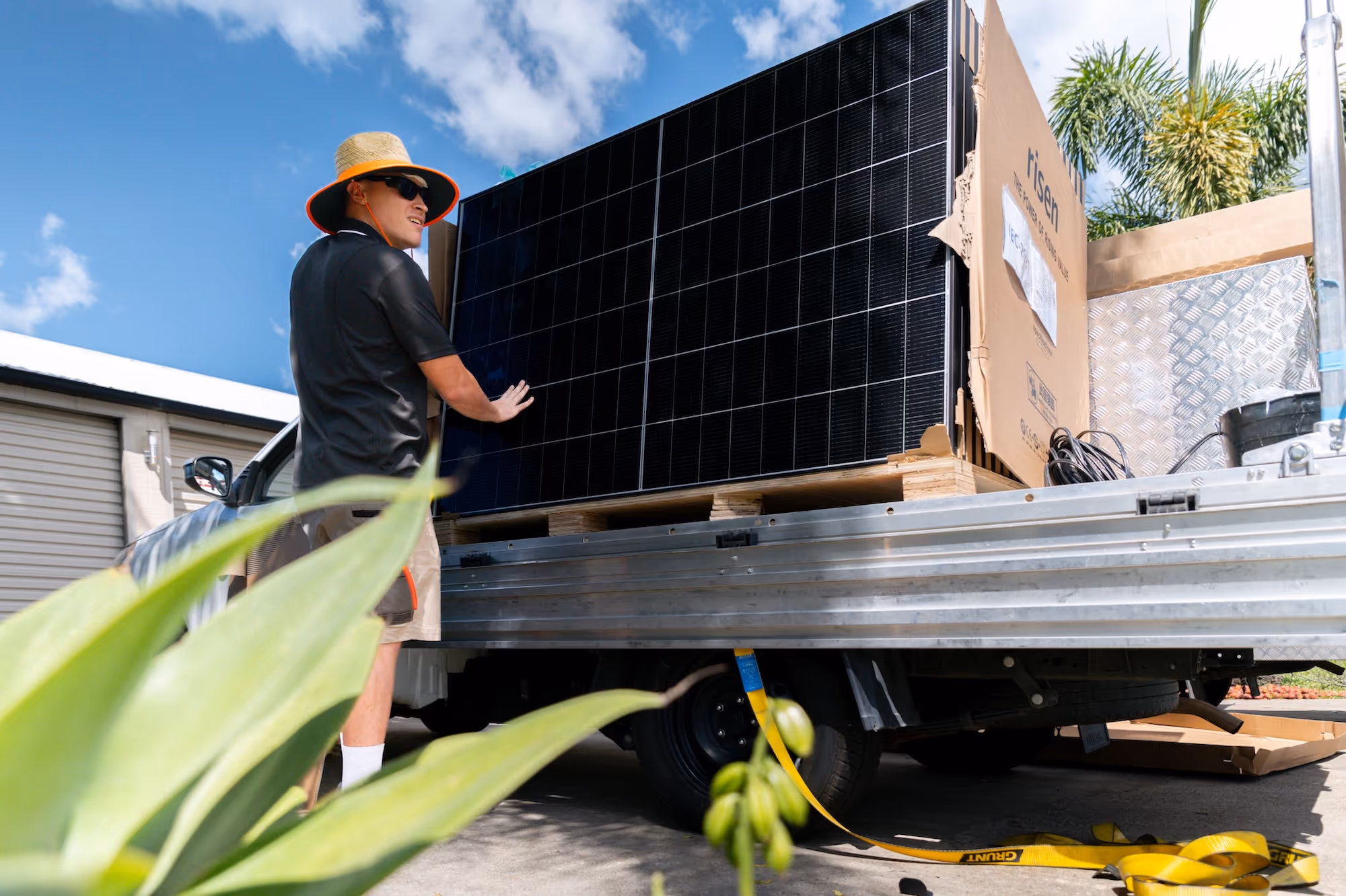 An LMS Electrical installer preparing to unload high-quality solar panels from the work truck.